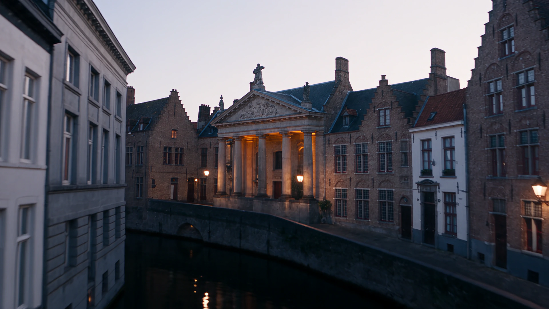 A Bruges square at dawn, a columned portico between gabled houses, the pavement still empty.